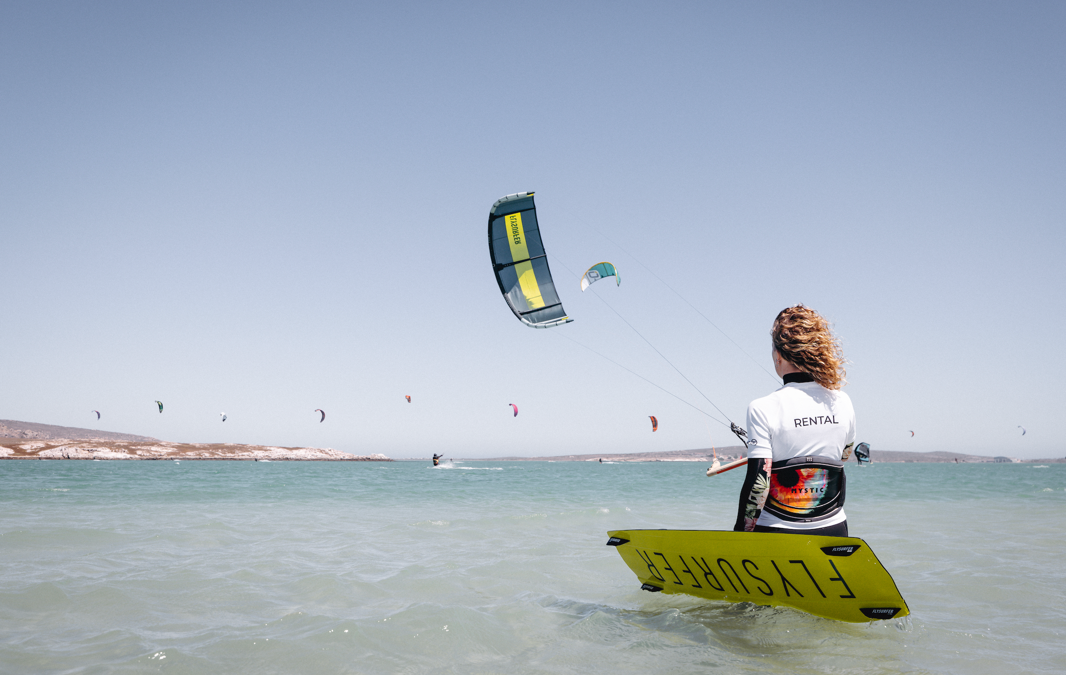 woman in the water using kitesurfing rental from onyx kiteboarding flysurfer material